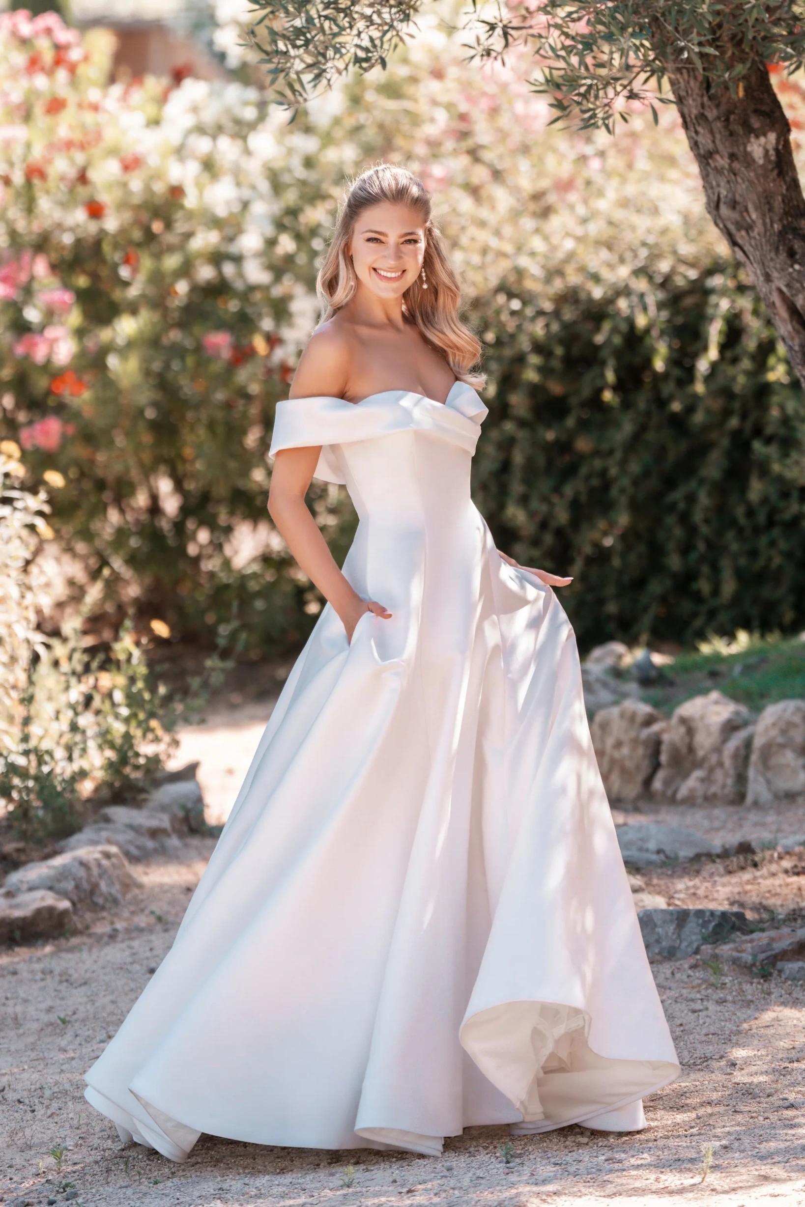 Model wearing a white gown by allure bridals